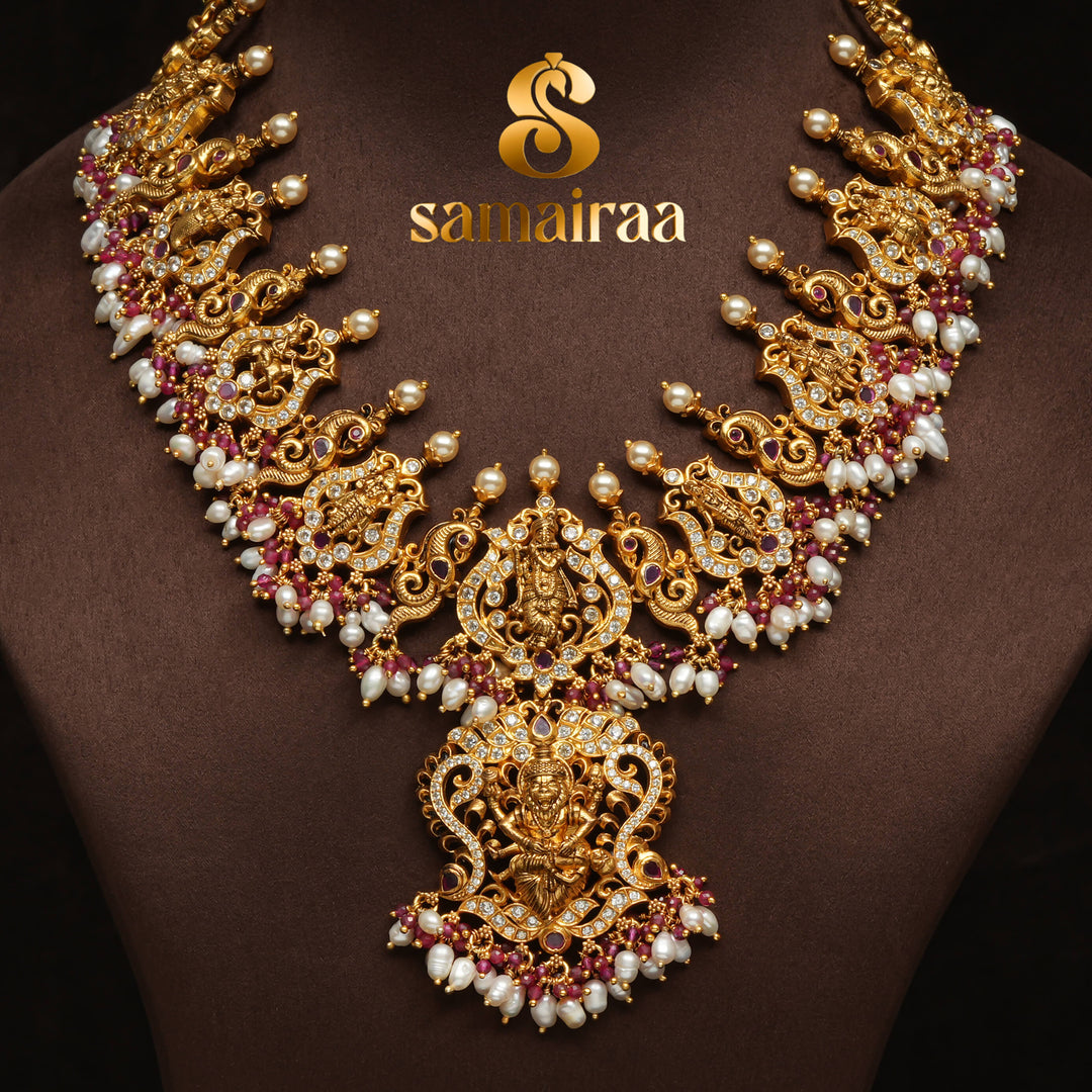 Traditional temple silver necklace with antique gold finish, pearl drops, pink ruby stones and intricate Lakshmi pendant design by Sri Fine Jewellery Hyderabad.
