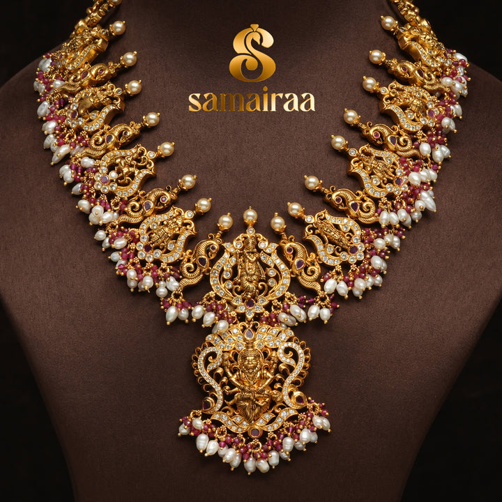 Traditional temple silver necklace with antique gold finish, pearl drops, pink ruby stones and intricate Lakshmi pendant design by Sri Fine Jewellery Hyderabad.
