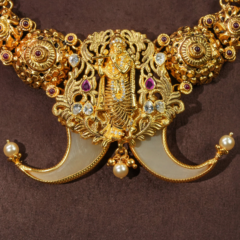 Close-up view of antique temple necklace in 92.5 silver with Krishna pendant, handcrafted south indian bridal jewellery with premium gold finish and traditional heritage design by Sri Fine Jewellery Punjagutta Hyderabad.