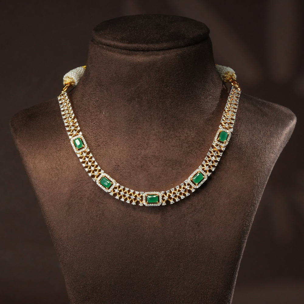 Luxury diamond-look silver cz emerald necklace with premium cz stones and semi-precious emerald stone in 92.5 silver, party wear jewellery with gold finish by Sri Fine Jewellery Punjagutta Hyderabad.
