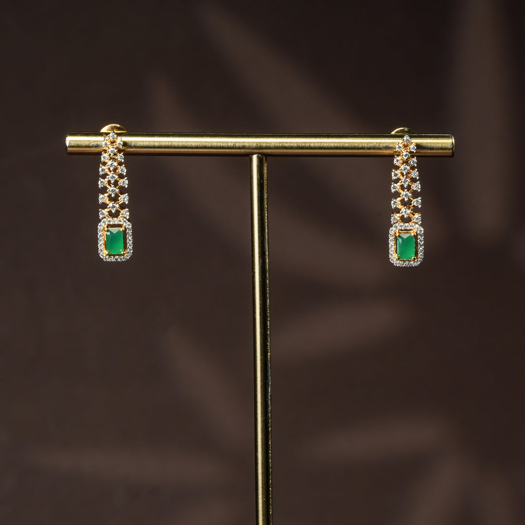 Luxury diamond-look silver cz emerald earrings set with premium cz stones and semi-precious emerald stone in 92.5 silver, party wear jewellery with gold finish by Sri Fine Jewellery Punjagutta Hyderabad.