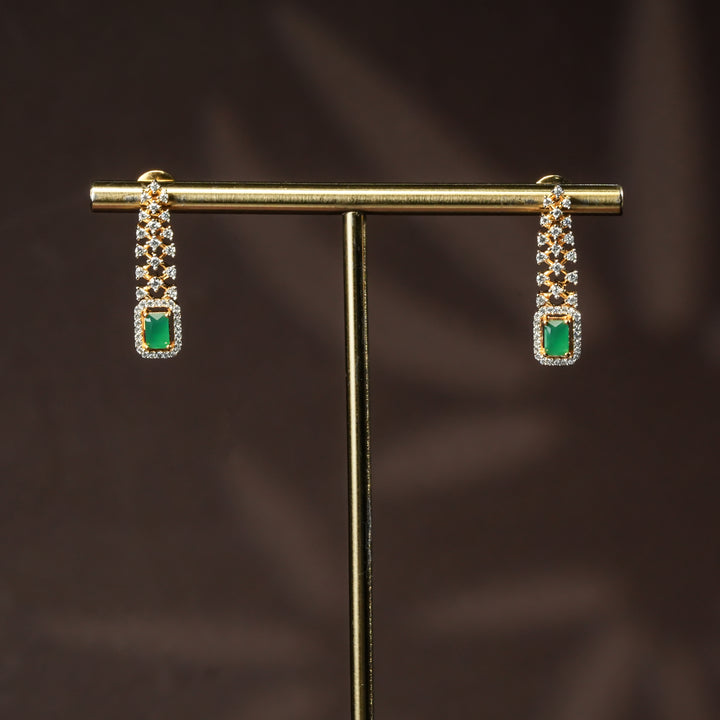 Luxury diamond-look silver cz emerald earrings set with premium cz stones and semi-precious emerald stone in 92.5 silver, party wear jewellery with gold finish by Sri Fine Jewellery Punjagutta Hyderabad.