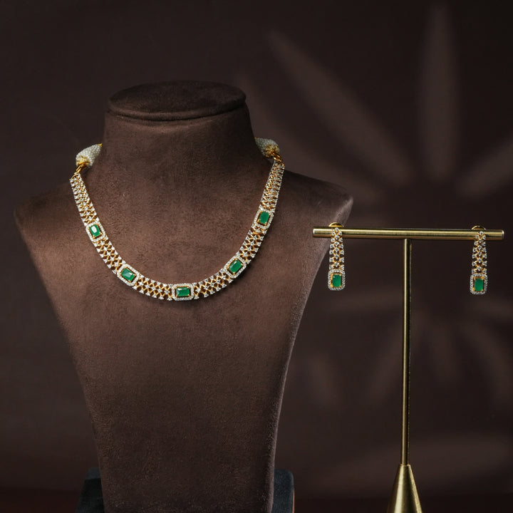 Luxury diamond-look silver cz emerald necklace set with premium cz stones and semi-precious emerald stone in 92.5 silver, party wear jewellery with gold finish by Sri Fine Jewellery Punjagutta Hyderabad.