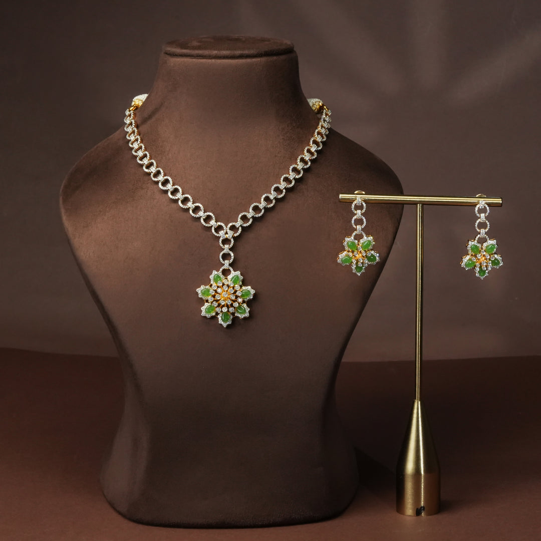 Luxury diamond-look silver cz emerald necklace set with premium cz stones and semi-precious emerald stone in 92.5 silver, party wear jewellery with gold finish by Sri Fine Jewellery Punjagutta Hyderabad.