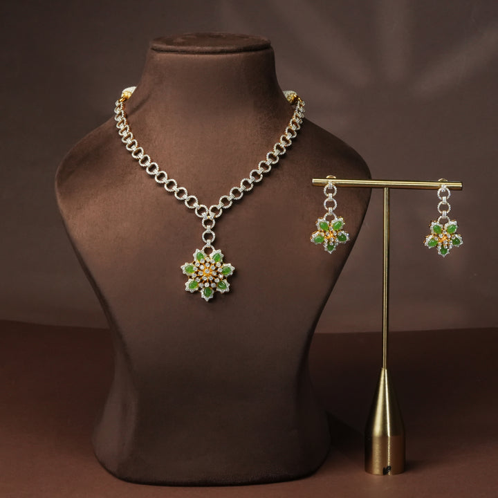 Luxury diamond-look silver cz emerald necklace set with premium cz stones and semi-precious emerald stone in 92.5 silver, party wear jewellery with gold finish by Sri Fine Jewellery Punjagutta Hyderabad.