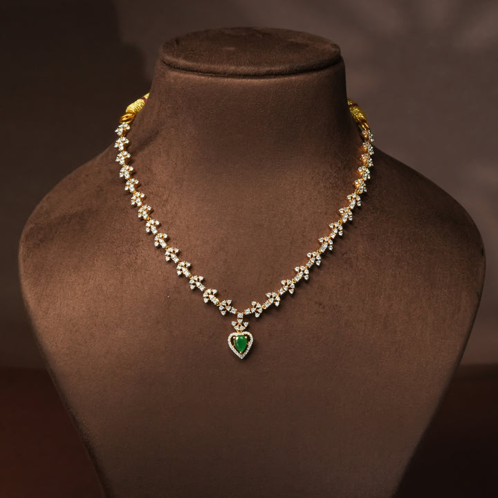 Luxury diamond-look silver cz emerald necklace with premium cz stones and semi-precious emerald stone in 92.5 silver, party wear jewellery with gold finish by Sri Fine Jewellery Punjagutta Hyderabad.