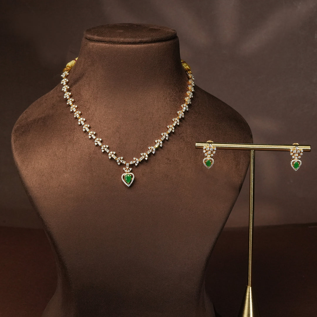 Luxury diamond-look silver cz emerald necklace set with premium cz stones and semi-precious emerald stone in 92.5 silver, party wear jewellery with gold finish by Sri Fine Jewellery Punjagutta Hyderabad.