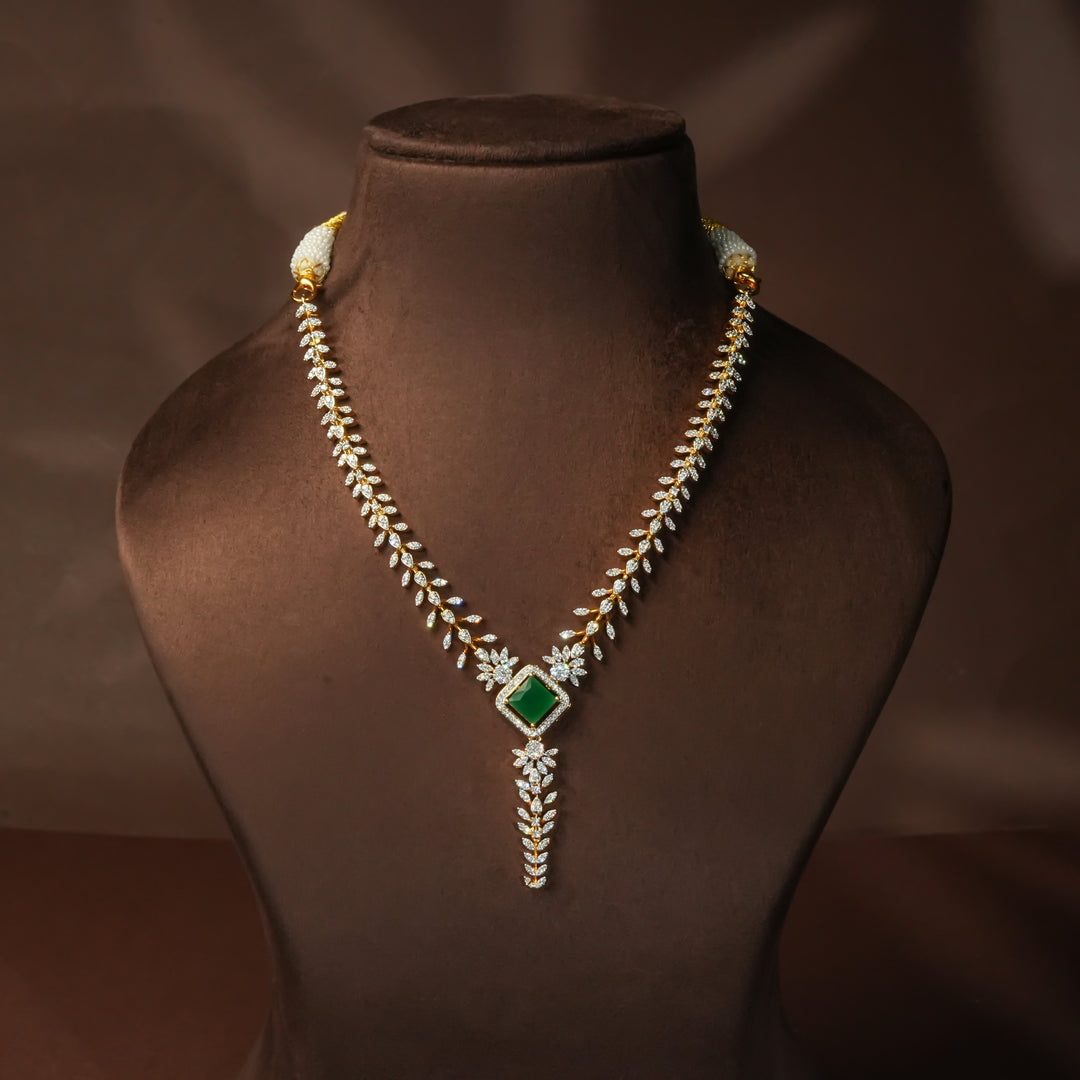 Luxury diamond-look silver cz emerald necklace with premium cz stones and semi-precious emerald stone in 92.5 silver, bridal wedding jewellery with gold finish by Sri Fine Jewellery Punjagutta Hyderabad.