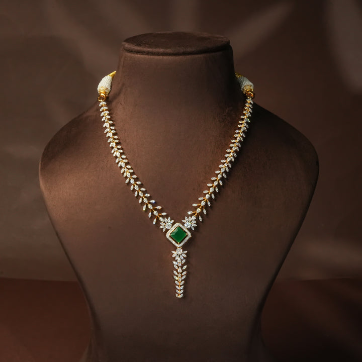Luxury diamond-look silver cz emerald necklace with premium cz stones and semi-precious emerald stone in 92.5 silver, bridal wedding jewellery with gold finish by Sri Fine Jewellery Punjagutta Hyderabad.