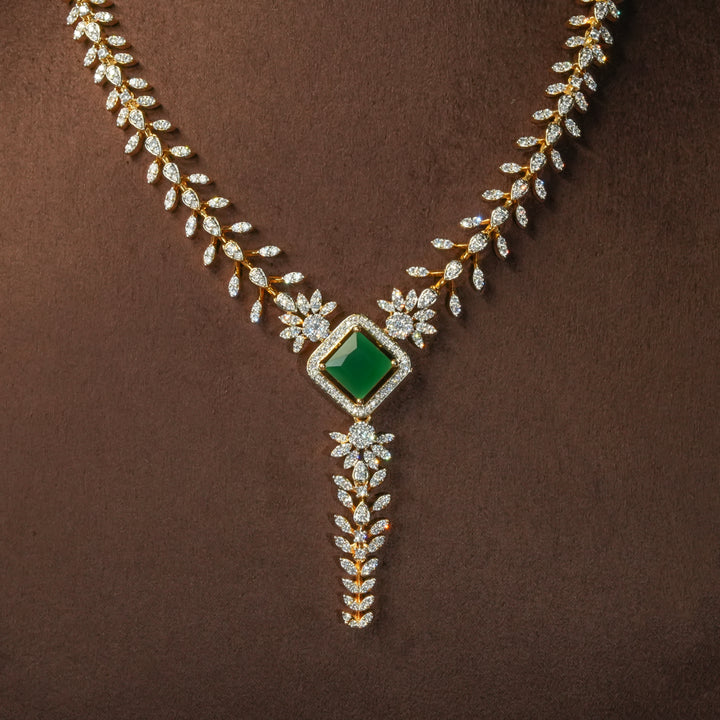 Luxury diamond-look silver cz emerald necklace with premium cz stones and semi-precious emerald stone in 92.5 silver, bridal wedding jewellery with gold finish by Sri Fine Jewellery Punjagutta Hyderabad.