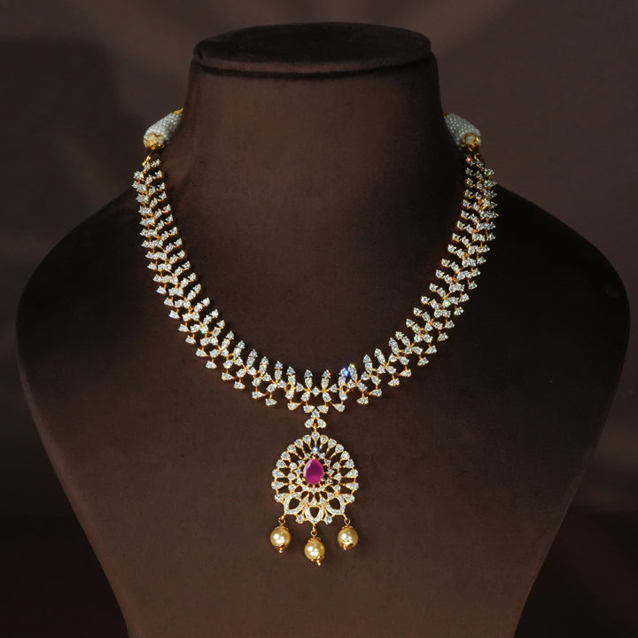 Luxury diamond-look silver cz ruby necklace with premium cz stones and semi-precious ruby stone in 92.5 silver, bridal wedding jewellery with gold finish by Sri Fine Jewellery Punjagutta Hyderabad.