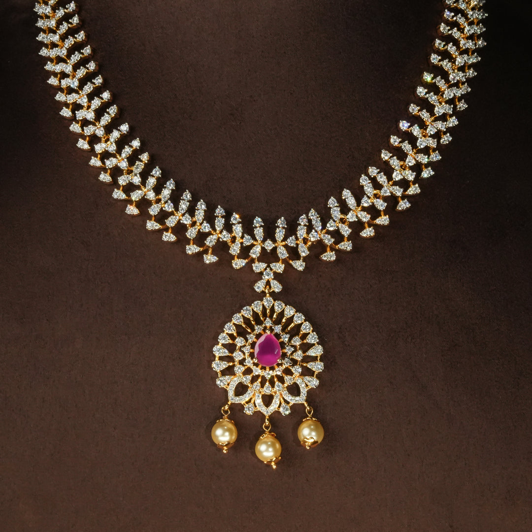 Luxury diamond-look silver cz ruby necklace with premium cz stones and semi-precious ruby stone in 92.5 silver, bridal wedding jewellery with gold finish by Sri Fine Jewellery Punjagutta Hyderabad.