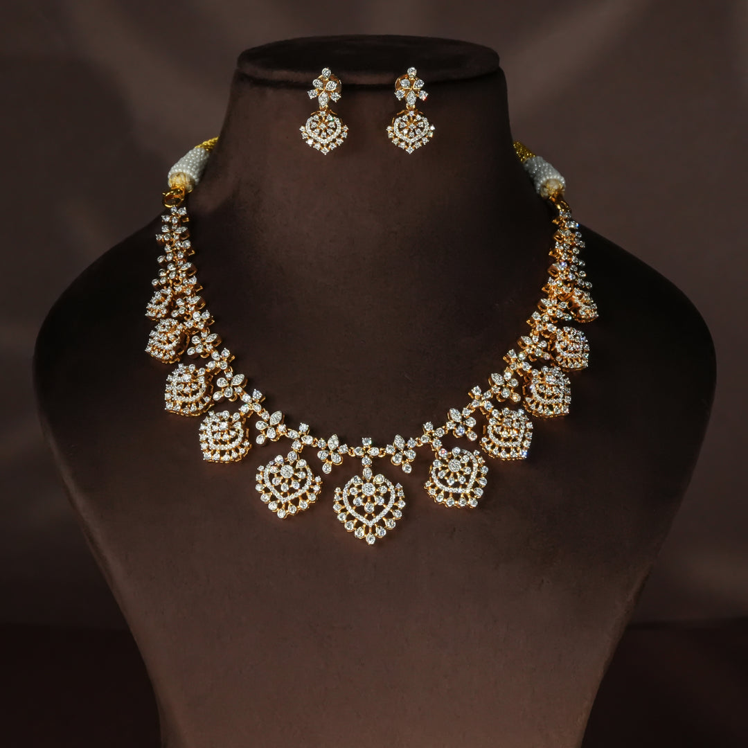 Luxury diamond-look silver necklace set with premium cz stones in 92.5 silver, bridal wedding jewellery with gold finish by Sri Fine Jewellery Punjagutta Hyderabad.
