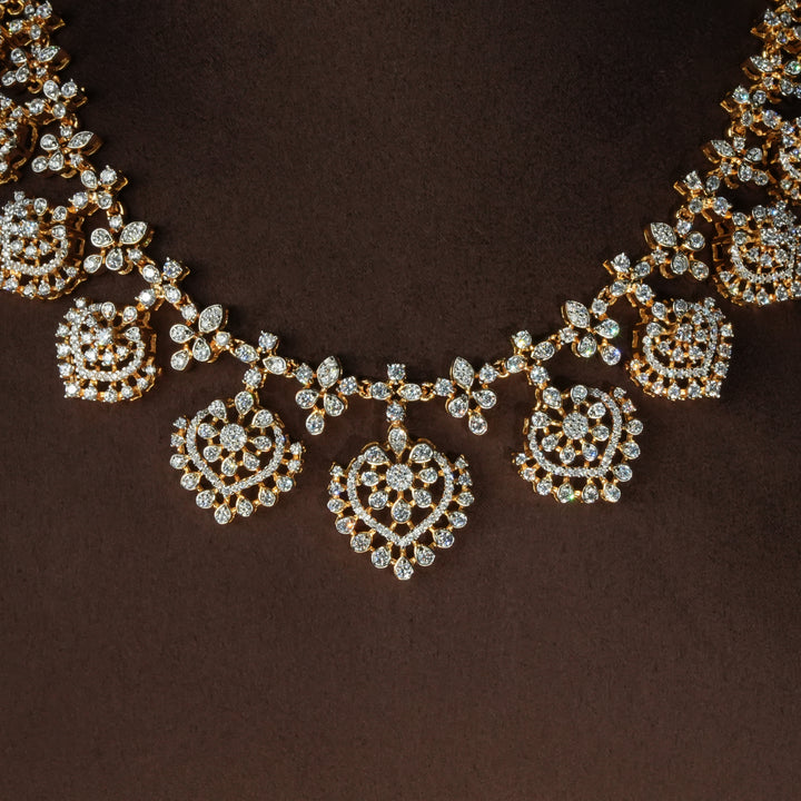Close-up view of luxury diamond-look silver necklace set with premium cz stones in 92.5 silver, bridal wedding jewellery with gold finish by Sri Fine Jewellery Punjagutta Hyderabad.