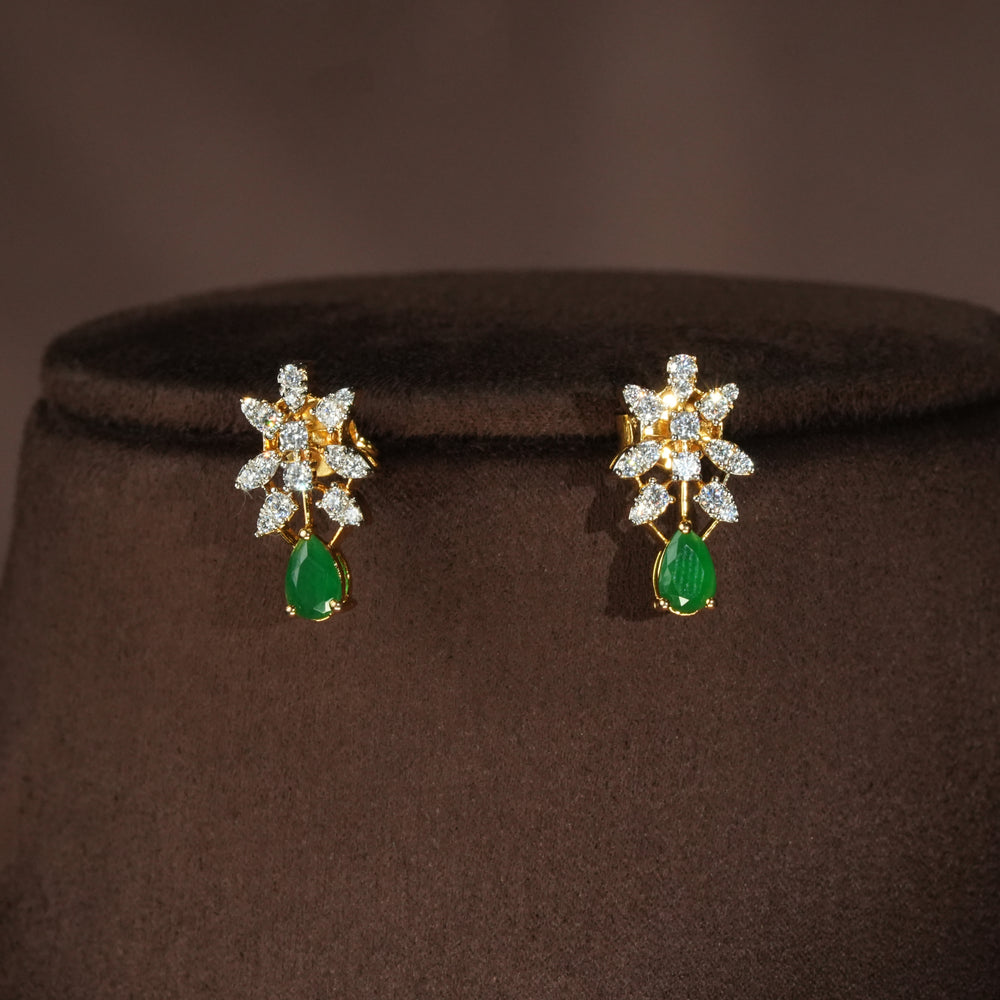 Luxury diamond-look silver earrings with premium cz stones and semi-precious emerald stones in 92.5 silver, bridal wedding jewellery with gold finish by Sri Fine Jewellery Punjagutta Hyderabad.