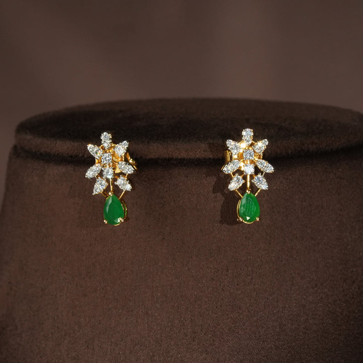 Luxury diamond-look silver earrings with premium cz stones and semi-precious emerald stones in 92.5 silver, bridal wedding jewellery with gold finish by Sri Fine Jewellery Punjagutta Hyderabad.