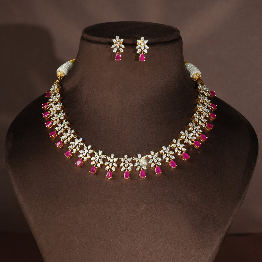 Luxury diamond-look silver necklace set with premium cz stones and semi-precious ruby stones in 92.5 silver, bridal wedding jewellery with gold finish by Sri Fine Jewellery Punjagutta Hyderabad.