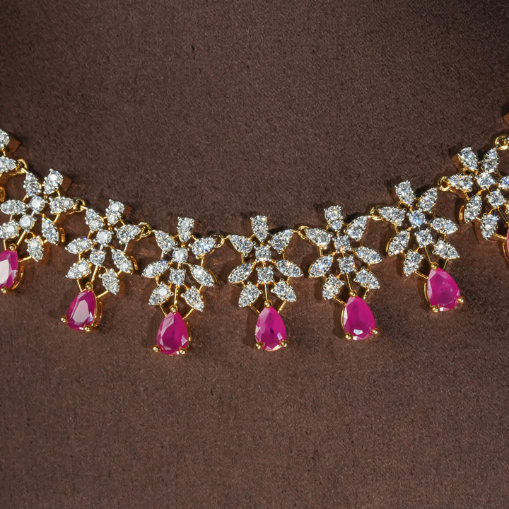 Close-up view of luxury diamond-look silver necklace set with premium cz stones and semi-precious ruby stones in 92.5 silver, bridal wedding jewellery with gold finish by Sri Fine Jewellery Punjagutta Hyderabad.