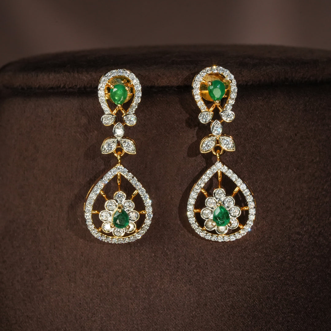 Luxury diamond-look silver earrings with premium cz stones and semi-precious emerald stones in 92.5 silver, bridal wedding jewellery with gold finish by Sri Fine Jewellery Punjagutta Hyderabad.