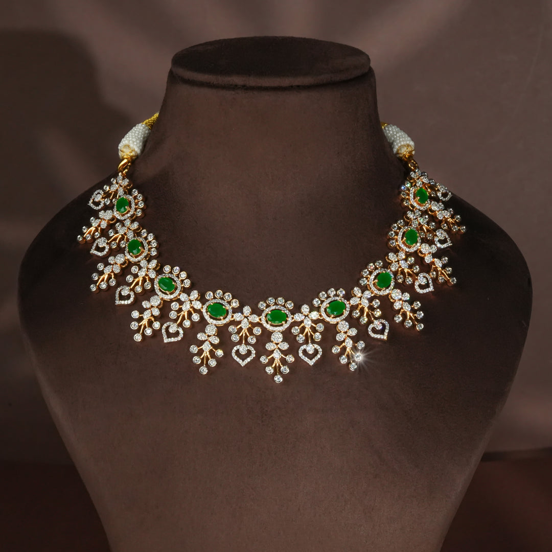Luxury diamond-look silver necklace with premium cz stones and semi-precious emerald stones in 92.5 silver, bridal wedding jewellery with gold finish by Sri Fine Jewellery Punjagutta Hyderabad.