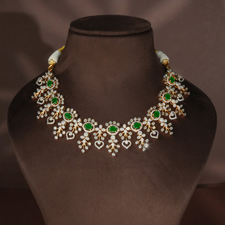 Luxury diamond-look silver necklace with premium cz stones and semi-precious emerald stones in 92.5 silver, bridal wedding jewellery with gold finish by Sri Fine Jewellery Punjagutta Hyderabad.