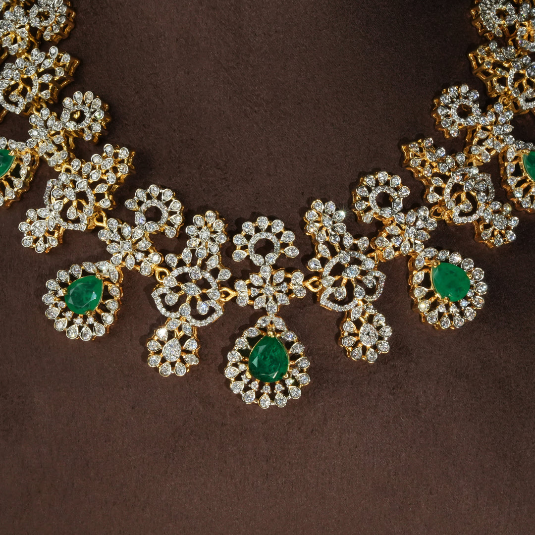 Luxury diamond-look silver necklace with premium cz stones and semi-precious emerald stones in 92.5 silver, bridal wedding jewellery with gold finish by Sri Fine Jewellery Punjagutta Hyderabad.