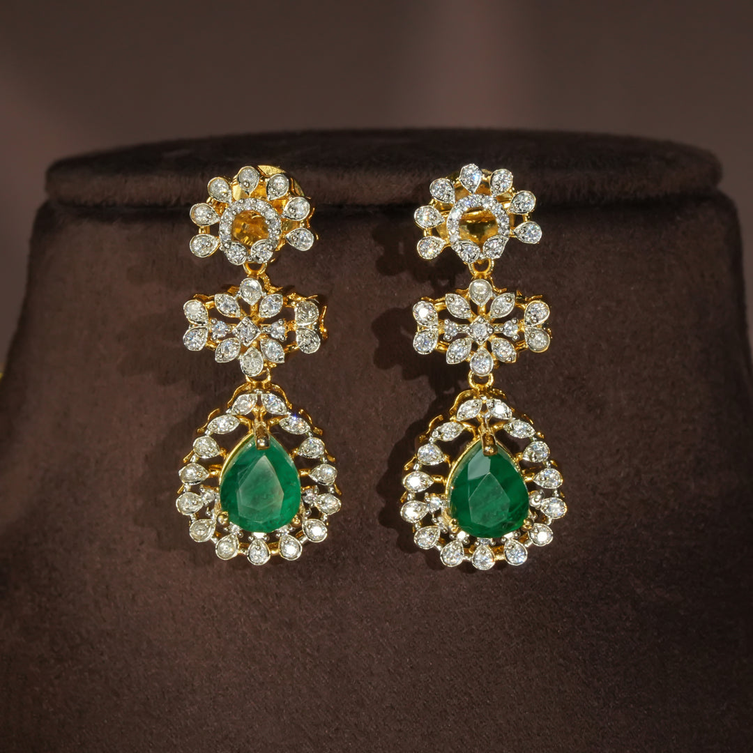 Luxury diamond-look silver earrings with premium cz stones and semi-precious emerald stones in 92.5 silver, bridal wedding jewellery with gold finish by Sri Fine Jewellery Punjagutta Hyderabad.
