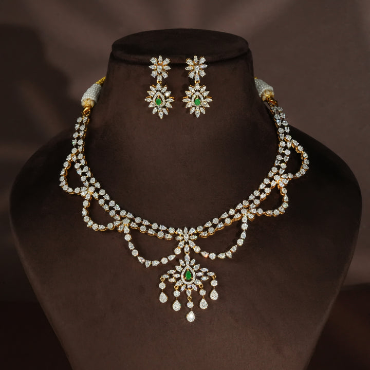 Luxury diamond-look silver necklace set with premium cz stones and semi-precious emerald stones in 92.5 silver, bridal wedding jewellery with gold finish by Sri Fine Jewellery Punjagutta Hyderabad.