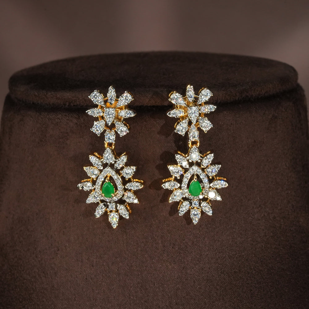 Luxury diamond-look silver earrings with premium cz stones and semi-precious emerald stones in 92.5 silver, bridal wedding jewellery with gold finish by Sri Fine Jewellery Punjagutta Hyderabad.