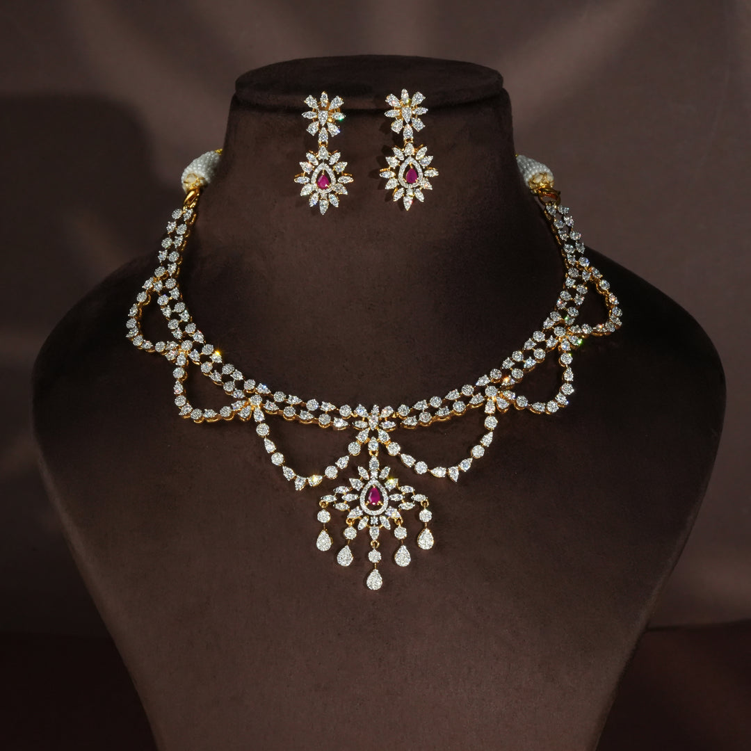 Luxury diamond-look silver necklace set with premium cz stones and semi-precious ruby stones in 92.5 silver, bridal wedding jewellery with gold finish by Sri Fine Jewellery Punjagutta Hyderabad.