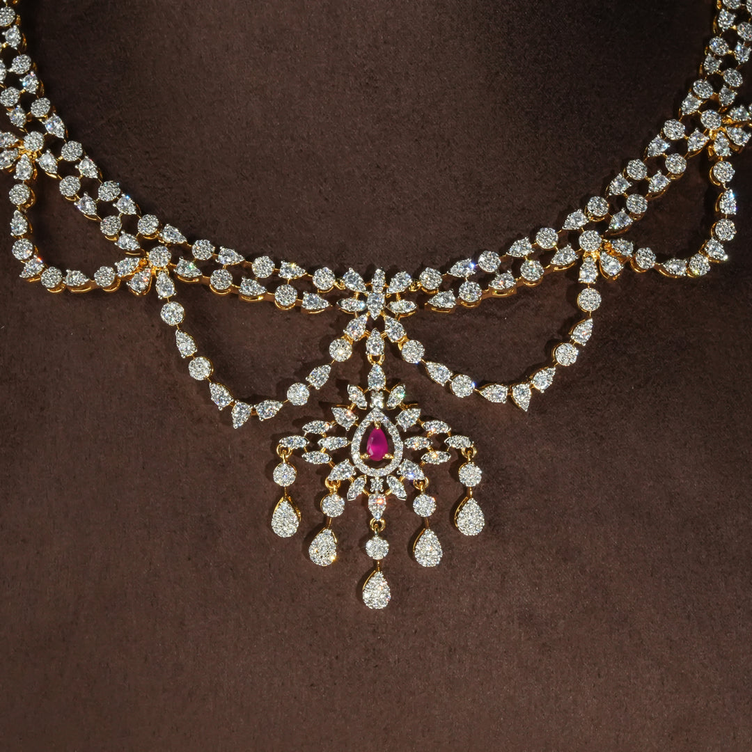 Luxury diamond-look silver necklace with premium cz stones and semi-precious ruby stones in 92.5 silver, bridal wedding jewellery with gold finish by Sri Fine Jewellery Punjagutta Hyderabad.