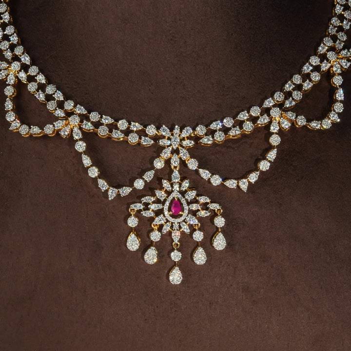 Luxury diamond-look silver necklace with premium cz stones and semi-precious ruby stones in 92.5 silver, bridal wedding jewellery with gold finish by Sri Fine Jewellery Punjagutta Hyderabad.