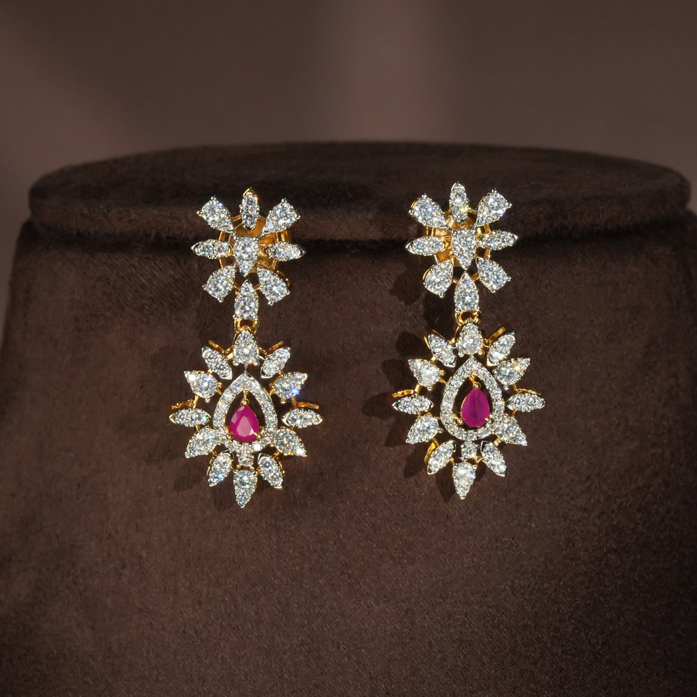 Luxury diamond-look silver earrings with premium cz stones and semi-precious ruby stones in 92.5 silver, bridal wedding jewellery with gold finish by Sri Fine Jewellery Punjagutta Hyderabad.