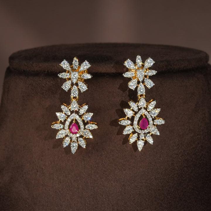 Luxury diamond-look silver earrings with premium cz stones and semi-precious ruby stones in 92.5 silver, bridal wedding jewellery with gold finish by Sri Fine Jewellery Punjagutta Hyderabad.