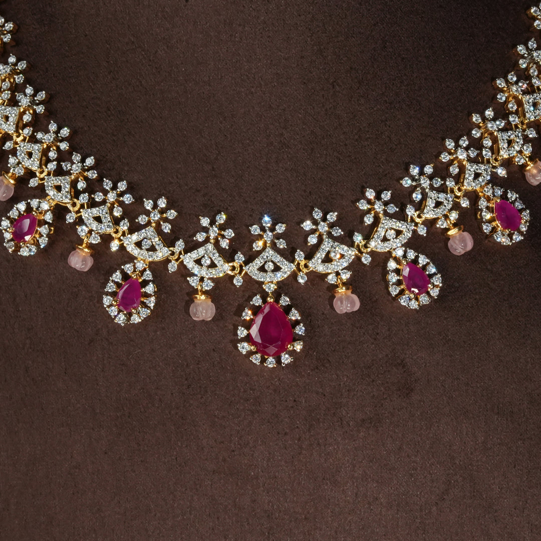 Close-up view of luxury diamond-look silver necklace with premium cz stones and semi-precious ruby stones in 92.5 silver, bridal wedding jewellery with gold finish by Sri Fine Jewellery Punjagutta Hyderabad.