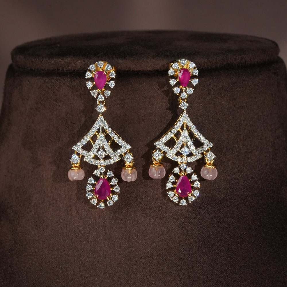 Luxury diamond-look silver earrings with premium cz stones and semi-precious ruby stones in 92.5 silver, bridal wedding jewellery with gold finish by Sri Fine Jewellery Punjagutta Hyderabad.