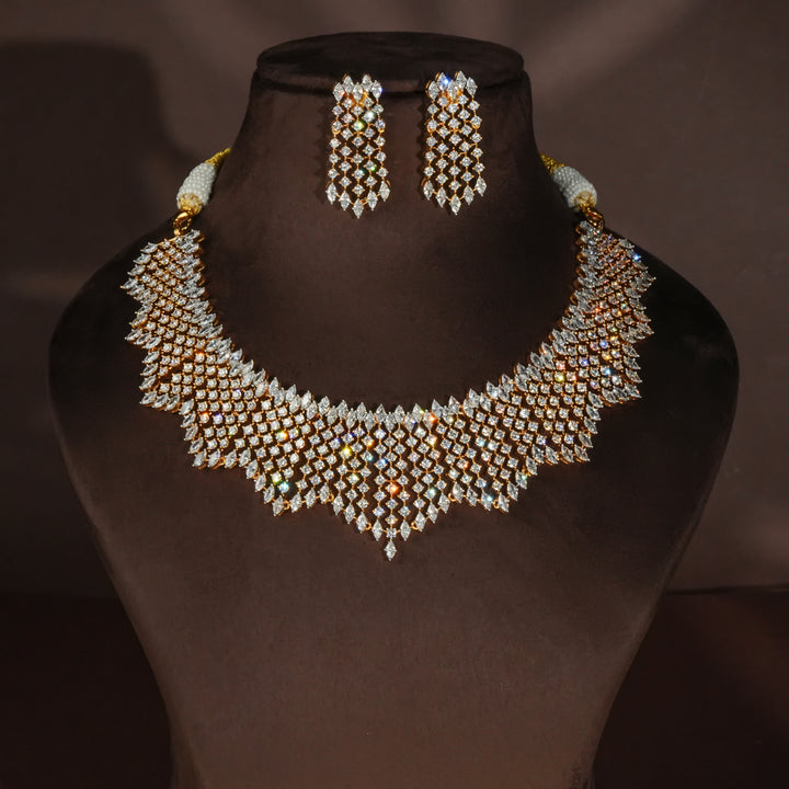 Luxury diamond-look silver necklace set with premium cz stones and matching earrings in 92.5 silver, bridal wedding jewellery with gold finish by Sri Fine Jewellery Punjagutta Hyderabad.
