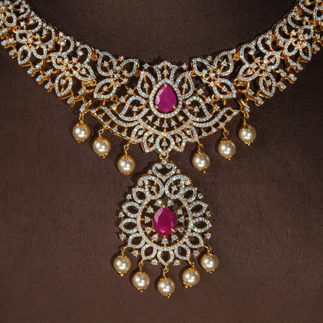 Luxury diamond-look silver necklace with premium cz stones and semi-precious ruby accents in 92.5 silver, bridal wedding jewellery with gold finish by Sri Fine Jewellery Punjagutta Hyderabad.