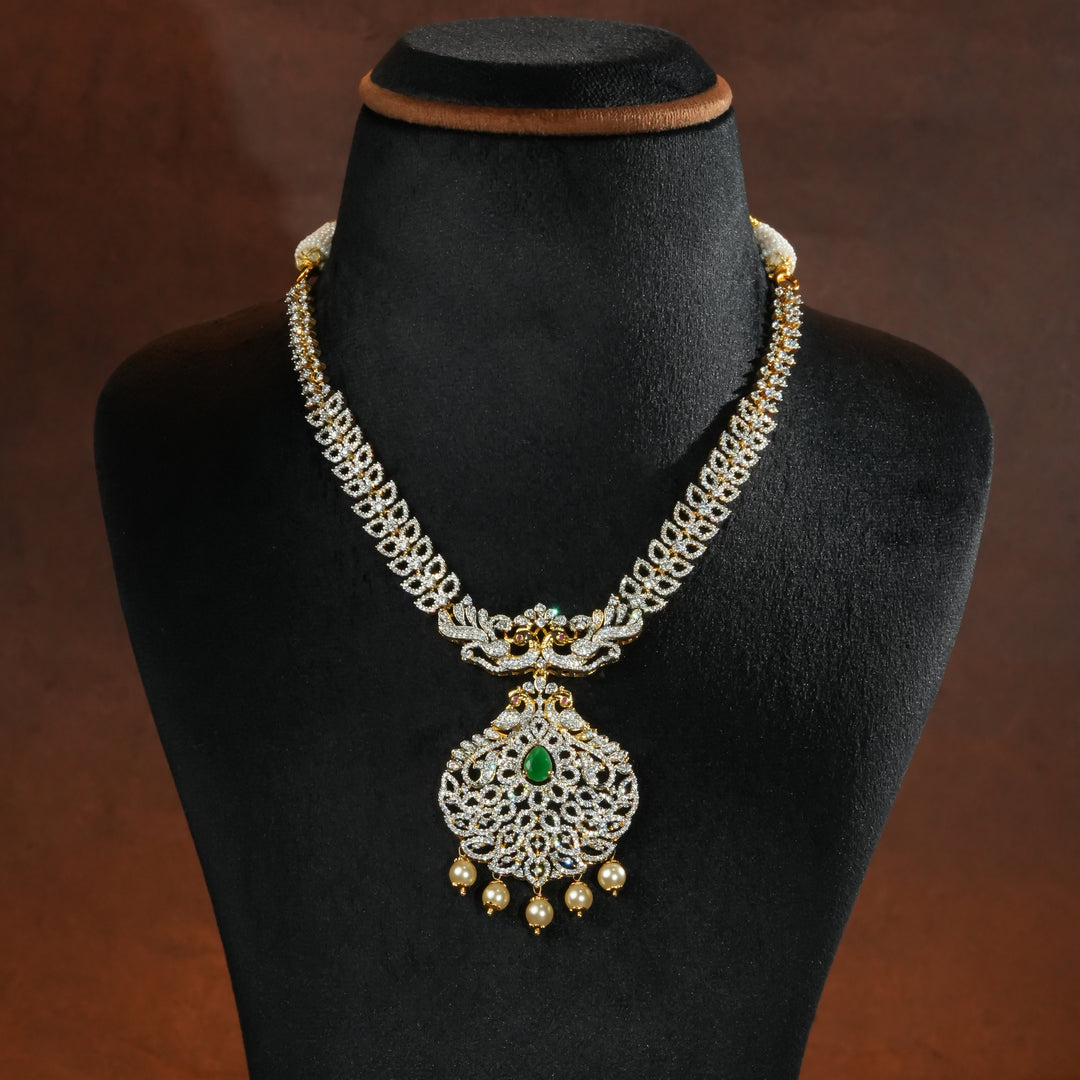 Luxury diamond-look silver necklace with premium cz stones and semi-precious emerald accents in 92.5 silver, bridal wedding jewellery with gold finish by Sri Fine Jewellery Punjagutta Hyderabad.