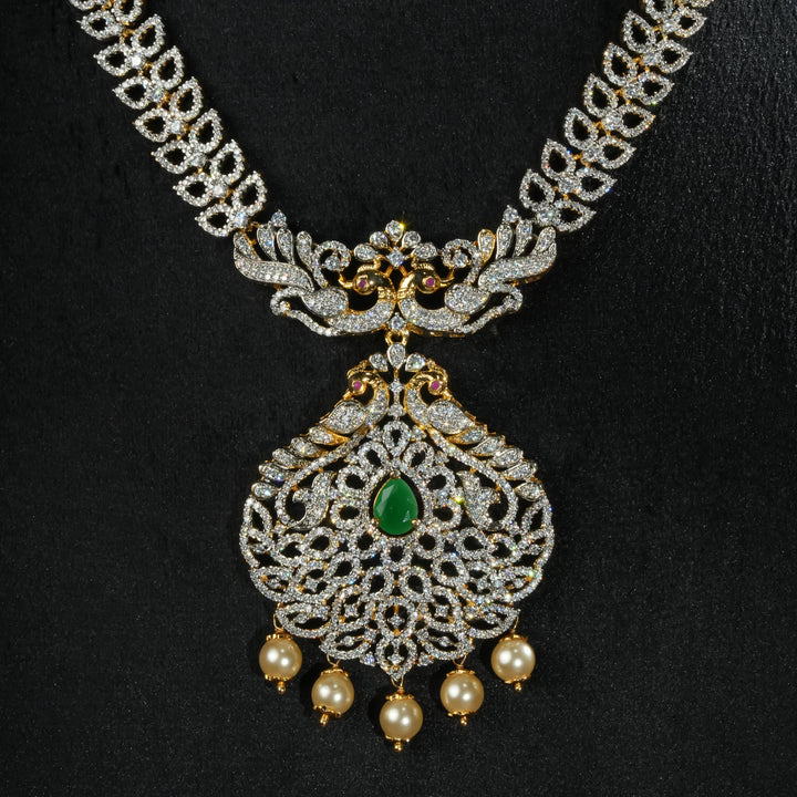Luxury diamond-look silver necklace with premium cz stones and semi-precious emerald accents in 92.5 silver, bridal wedding jewellery with gold finish by Sri Fine Jewellery Punjagutta Hyderabad.