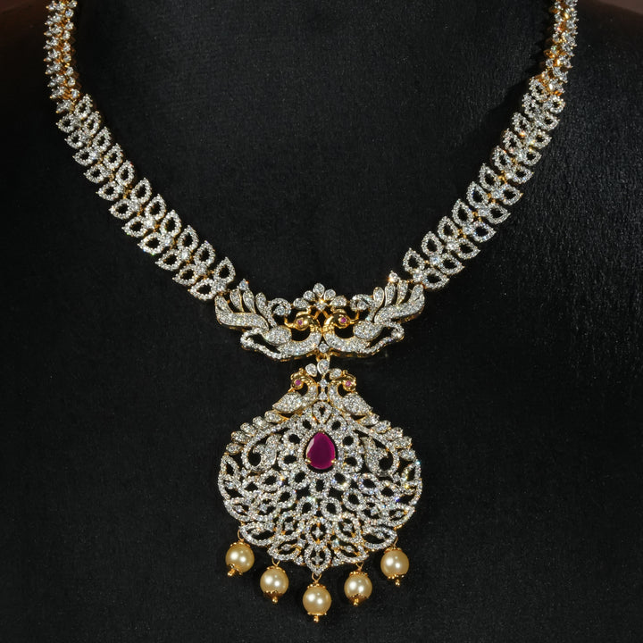 Luxury diamond-look silver necklace with premium cz stones and semi-precious ruby accents in 92.5 silver, bridal wedding jewellery with gold finish by Sri Fine Jewellery Punjagutta Hyderabad.
