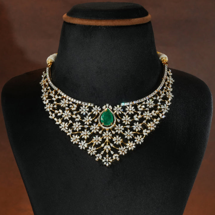 Luxury diamond-look silver necklace with premium cz stones and semi-precious emerald stone in 92.5 silver, bridal wedding jewellery with gold finish by Sri Fine Jewellery Punjagutta Hyderabad.