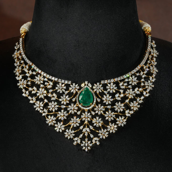 Luxury diamond-look silver necklace with premium cz stones and semi-precious emerald stone in 92.5 silver, bridal wedding jewellery with gold finish by Sri Fine Jewellery Punjagutta Hyderabad.