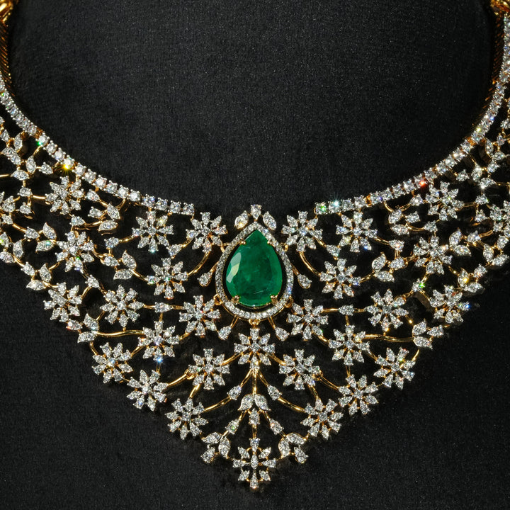 Luxury diamond-look silver necklace with premium cz stones and semi-precious emerald stone in 92.5 silver, bridal wedding jewellery with gold finish by Sri Fine Jewellery Punjagutta Hyderabad.