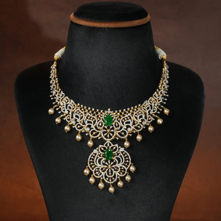 Luxury diamond-look silver necklace with premium cz stones and semi-precious emerald stone in 92.5 silver, bridal wedding jewellery with gold finish by Sri Fine Jewellery Punjagutta Hyderabad.