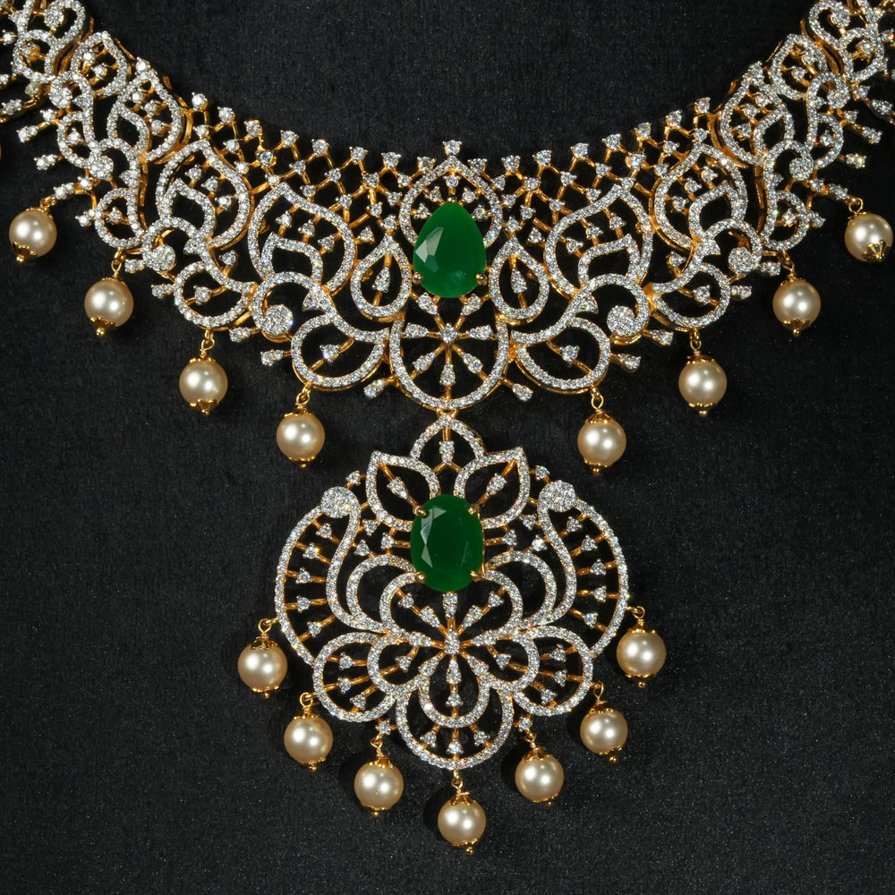 Luxury diamond-look silver necklace with premium cz stones and semi-precious emerald stone in 92.5 silver, bridal wedding jewellery with gold finish by Sri Fine Jewellery Punjagutta Hyderabad.