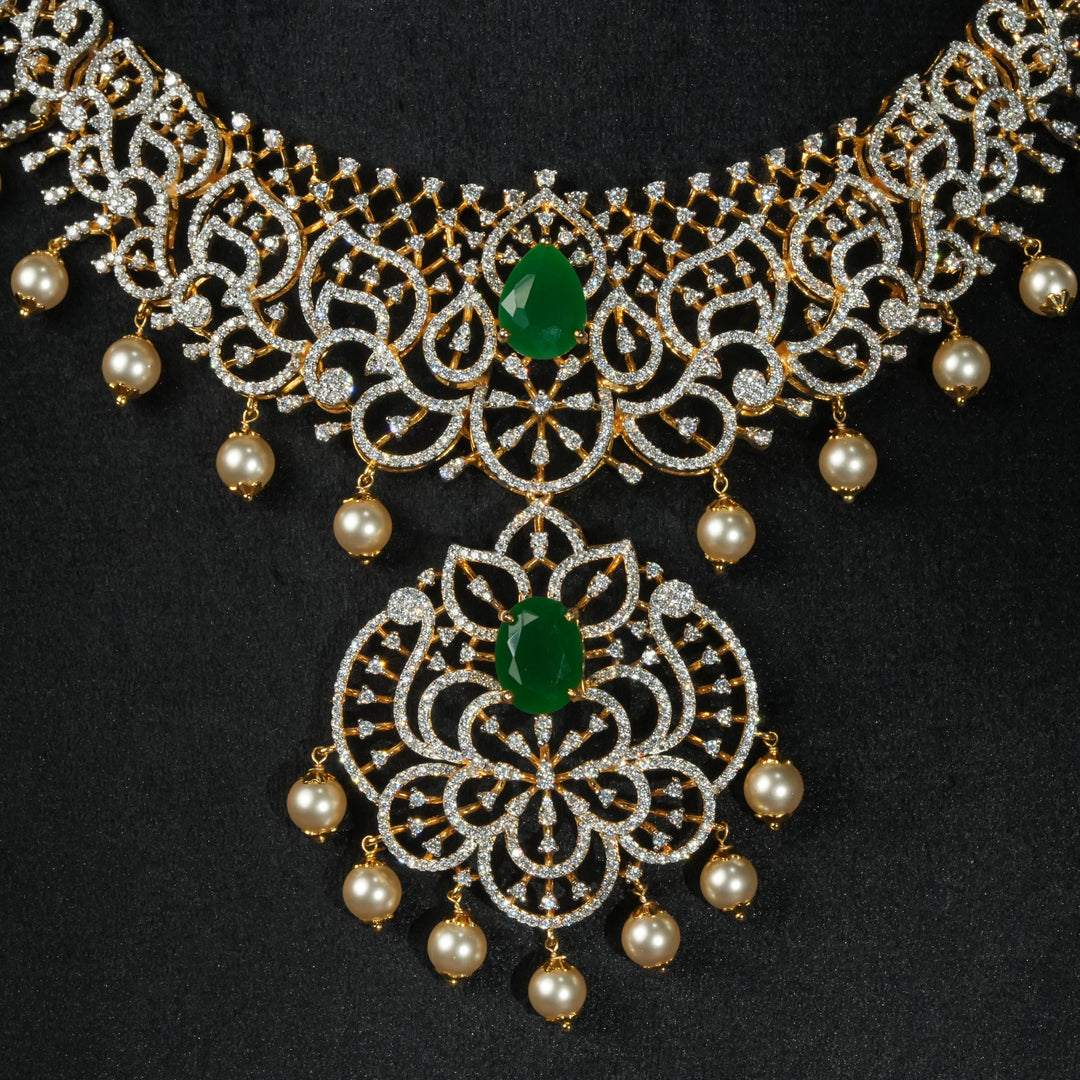 Luxury diamond-look silver necklace with premium cz stones and semi-precious emerald stone in 92.5 silver, bridal wedding jewellery with gold finish by Sri Fine Jewellery Punjagutta Hyderabad.