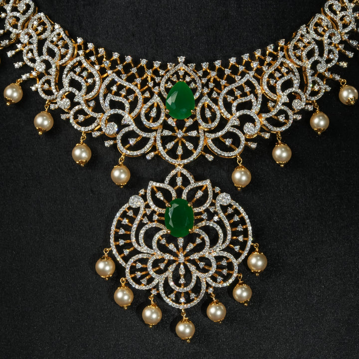 Luxury diamond-look silver necklace with premium cz stones and semi-precious emerald stone in 92.5 silver, bridal wedding jewellery with gold finish by Sri Fine Jewellery Punjagutta Hyderabad.