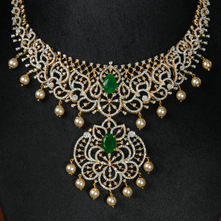 Luxury diamond-look silver necklace with premium cz stones and semi-precious emerald stone in 92.5 silver, bridal wedding jewellery with gold finish by Sri Fine Jewellery Punjagutta Hyderabad.