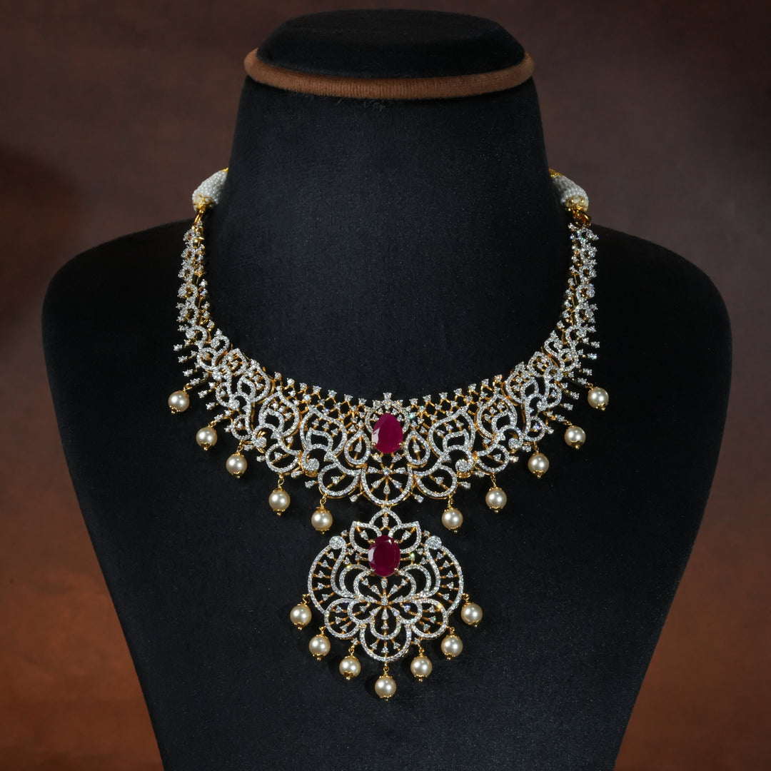 Luxury diamond-look silver necklace with premium cz stones and semi-precious ruby stone in 92.5 silver, bridal wedding jewellery with gold finish by Sri Fine Jewellery Punjagutta Hyderabad.